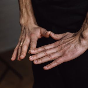 Close-up of hands in a mindful gesture.